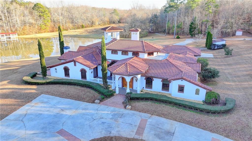 1540 Lipscomb Road Social Circle, GA 30025 - Photo 89 of 130 a view of a patio with a table and chairs under an umbrella