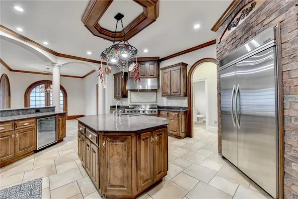 a large kitchen with stainless steel appliances granite countertop a stove a sink and a microwave