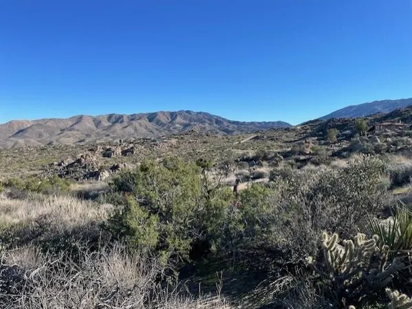 a view of a large mountain with mountains in the background