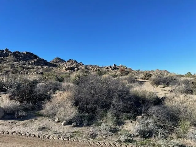 a view of a large mountain with mountains in the background