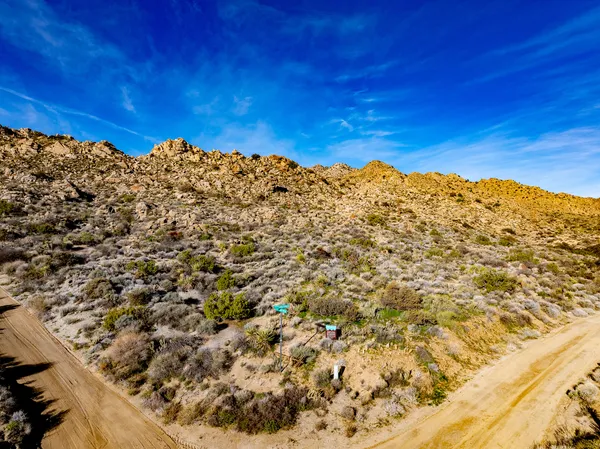 a view of a large building with mountains in the background