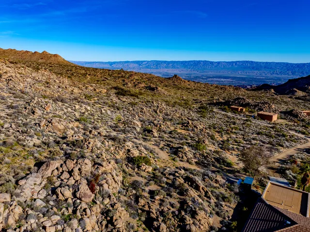 a view of a large mountain with mountains in the background