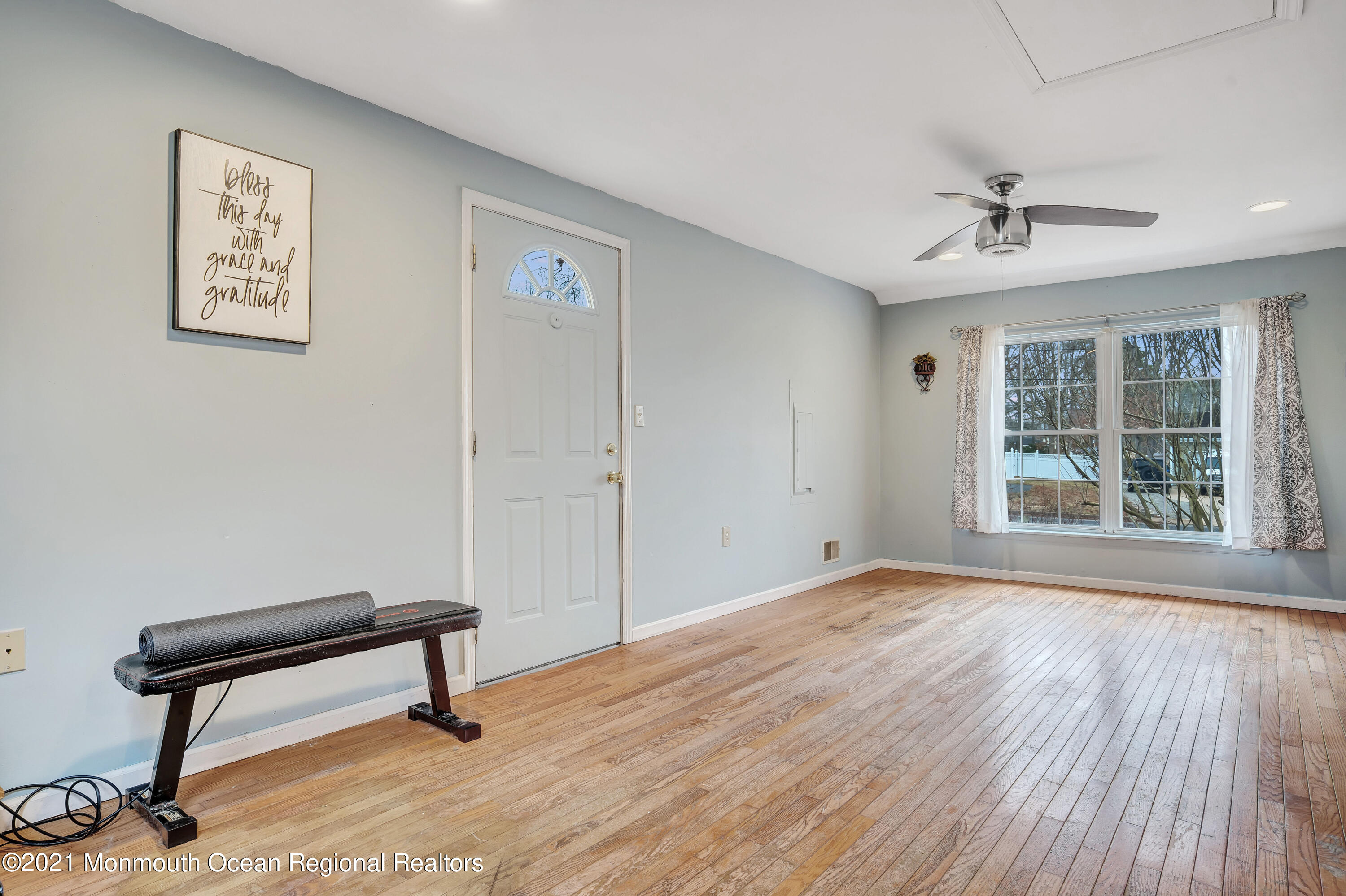 262 Privateer Road Manahawkin, NJ 08050 - Photo 14 of 20 a view of an empty room with a window and wooden floor