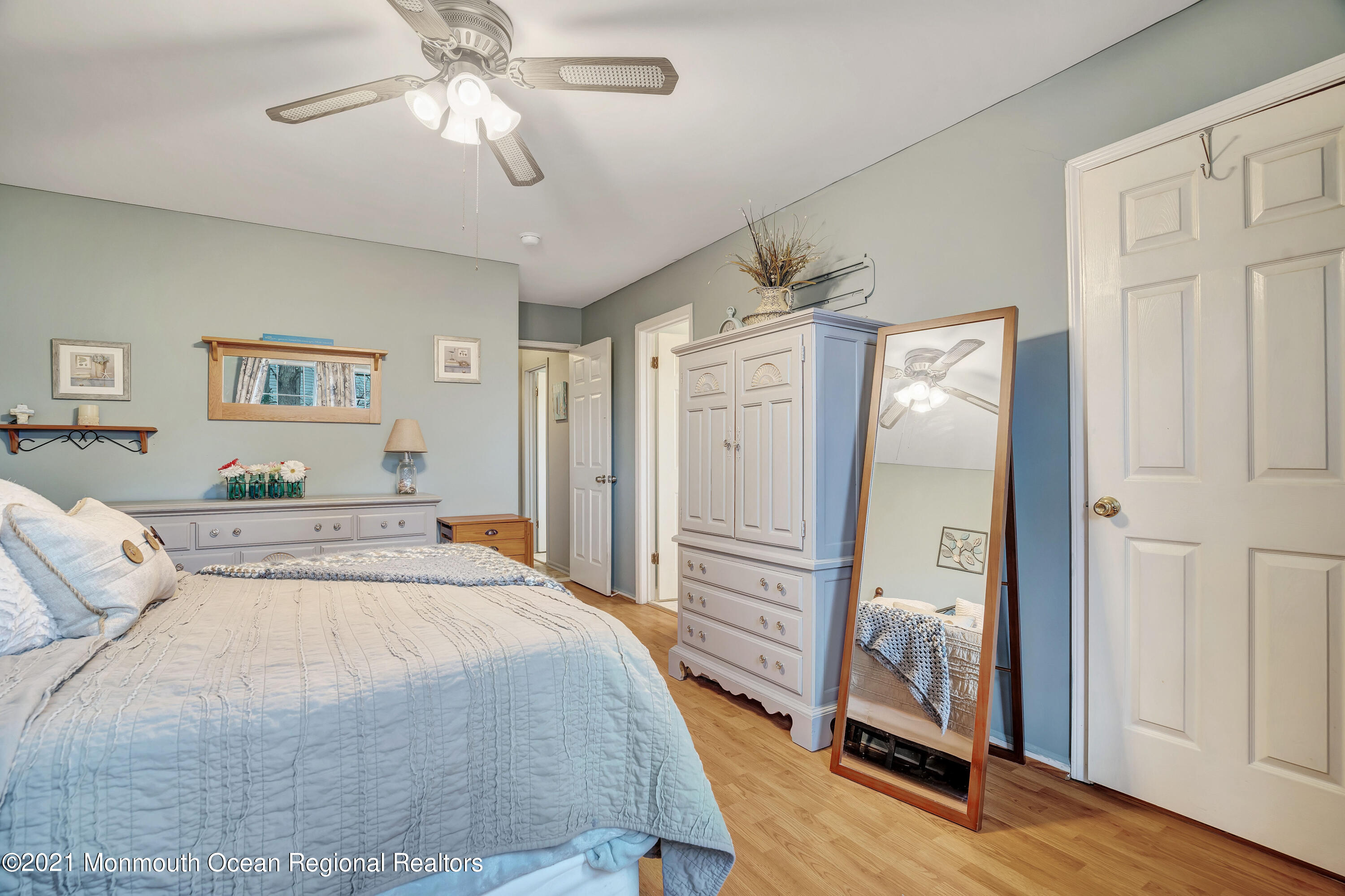 262 Privateer Road Manahawkin, NJ 08050 - Photo 19 of 20 a spacious bedroom with a bed and a chandelier