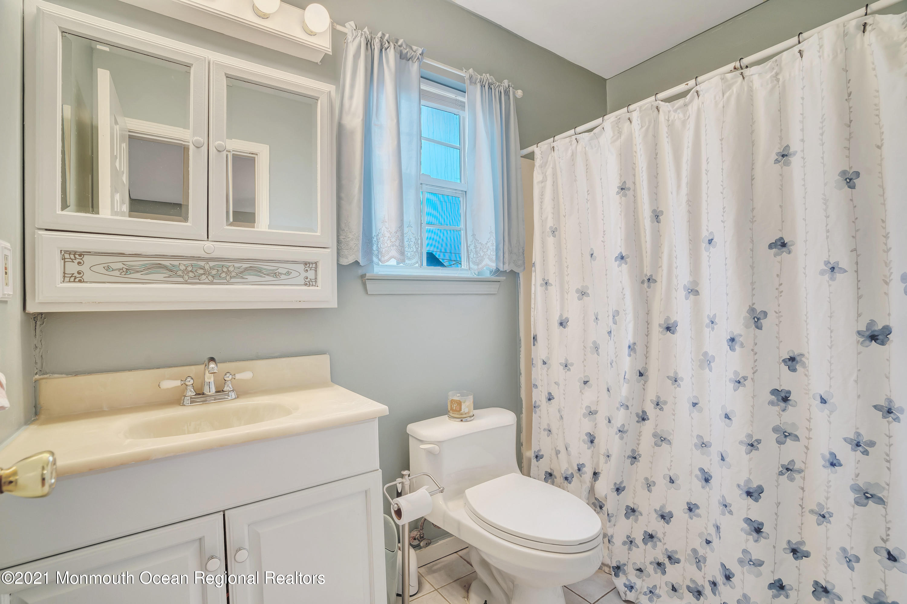 262 Privateer Road Manahawkin, NJ 08050 - Photo 20 of 20 a bathroom with a sink a toilet and a mirror