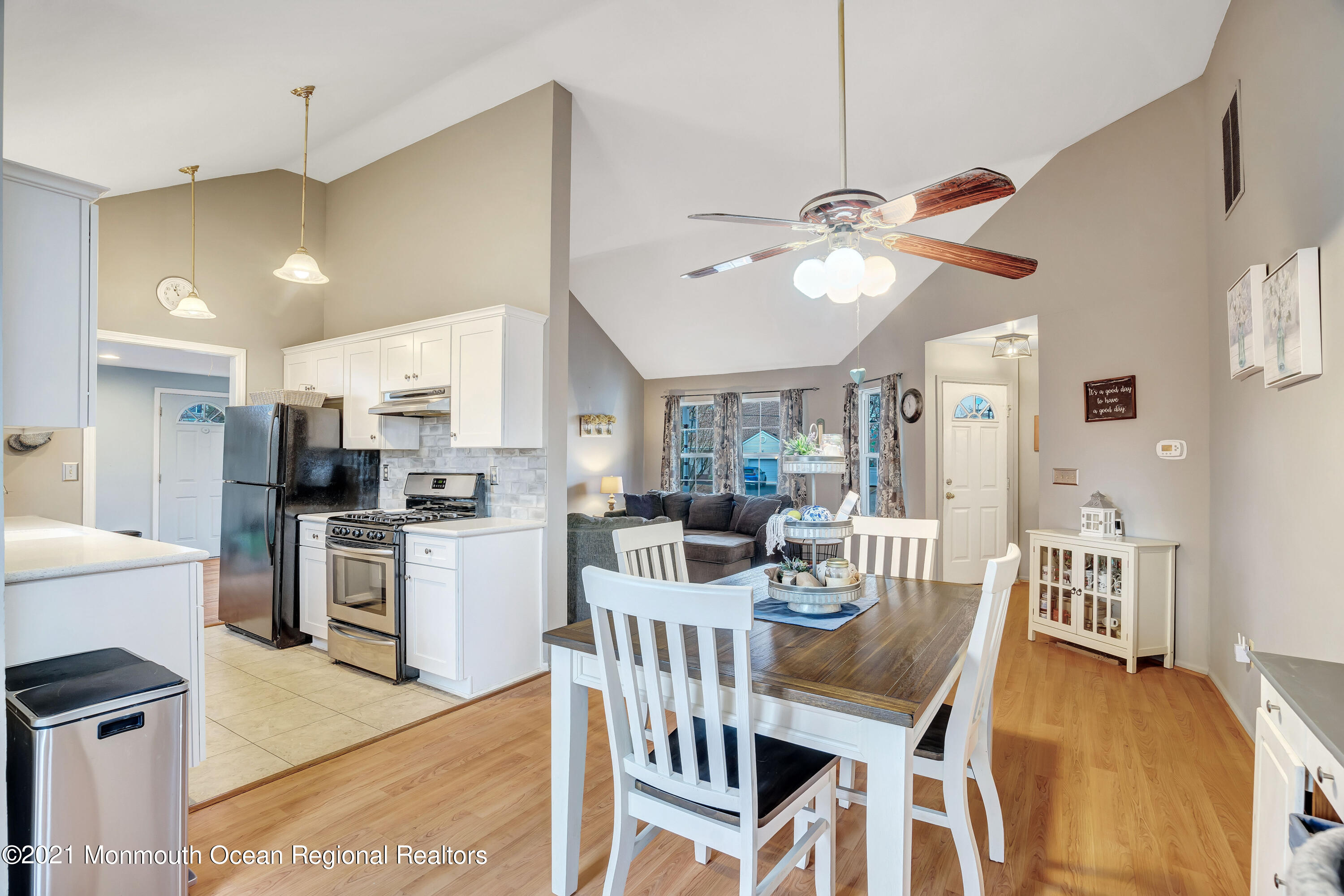 262 Privateer Road Manahawkin, NJ 08050 - Photo 6 of 20 a view of a dining room and livingroom with furniture a kitchen appliances and a chandelier