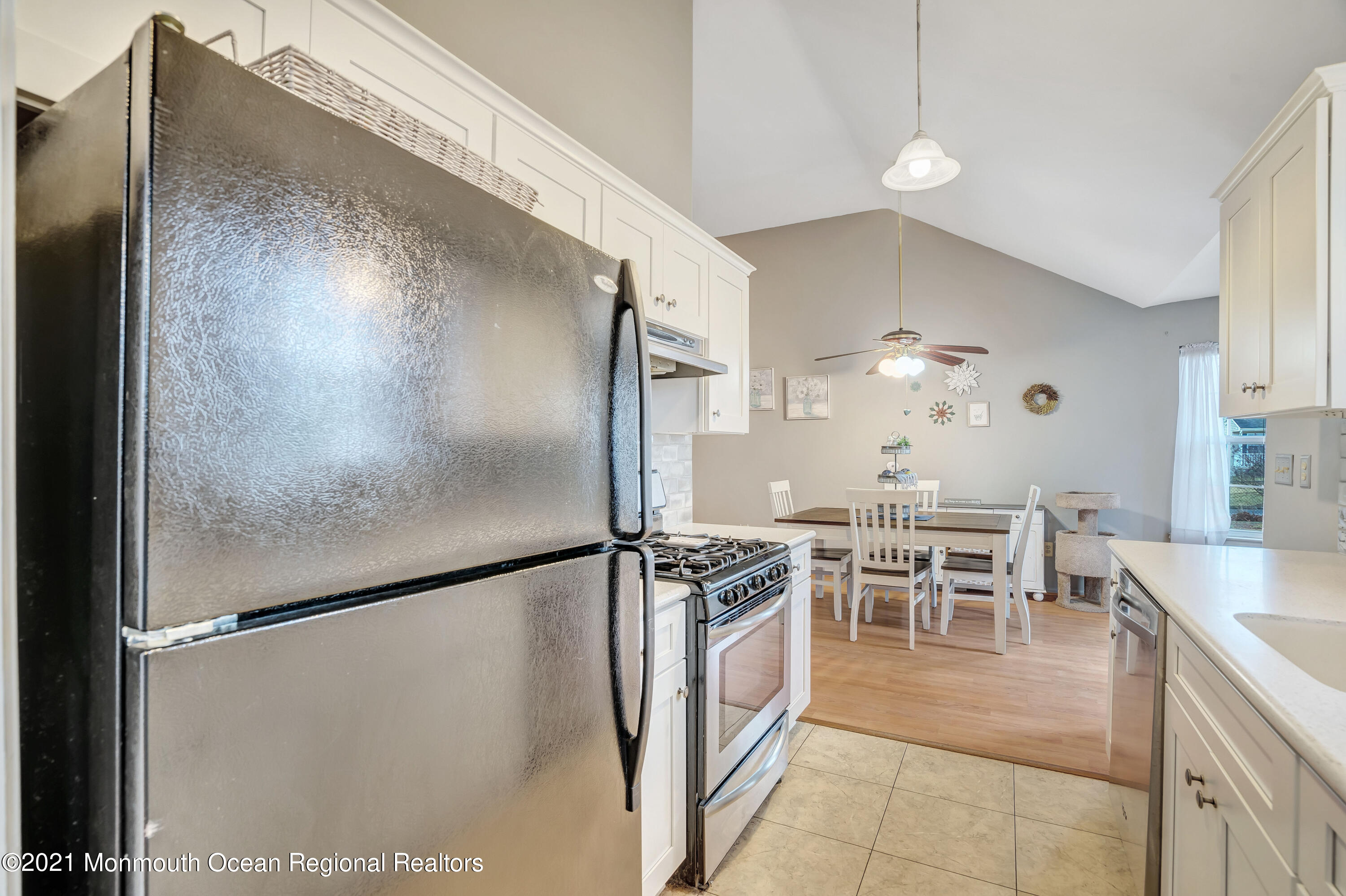 262 Privateer Road Manahawkin, NJ 08050 - Photo 9 of 20 a kitchen with stainless steel appliances granite countertop a refrigerator and a table