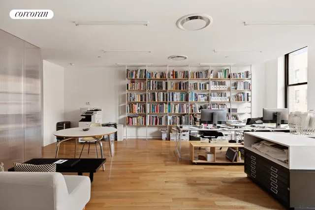 a view of a workspace with bookshelf