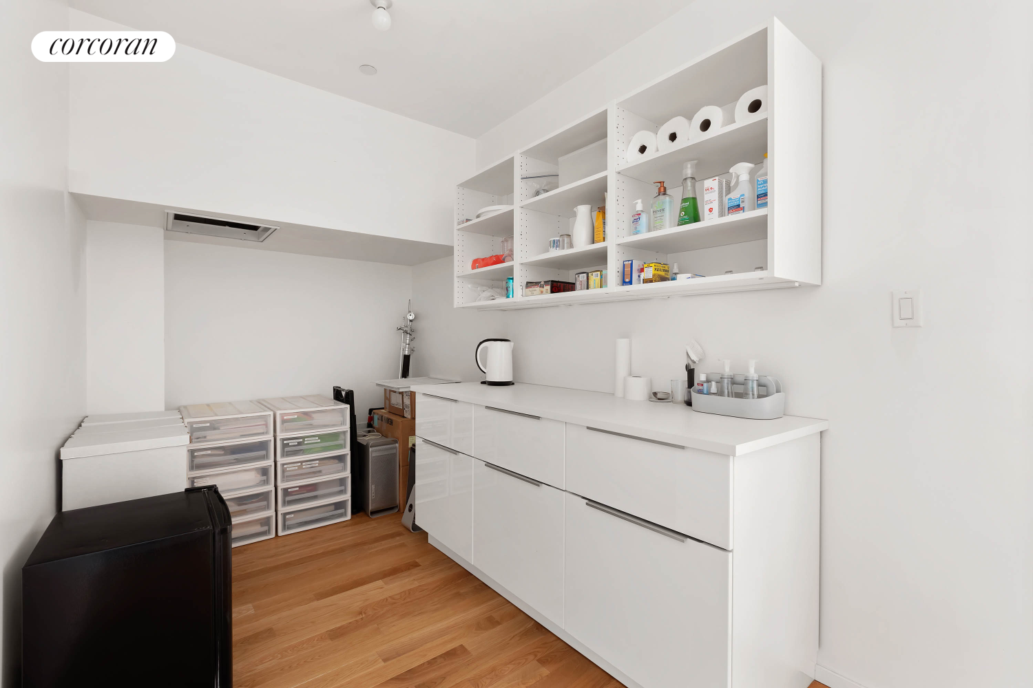 53 Elizabeth Street, Unit 4A Manhattan, NY 10013 - Photo 8 of 11 a view of cabinets with wooden floor washer and dryer