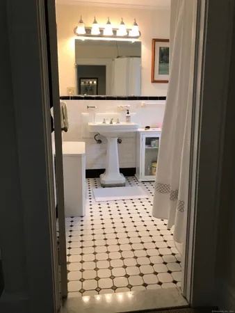 a bathroom with a sink a mirror and shower