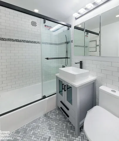 a bathroom with a sink toilet and shower