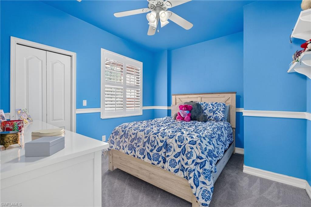 9970 Rookery Circle Estero, FL 33928 - Photo 42 of 50 Recessed lighting, ceiling fan, white bi-fold closet doors, white plantation shutters, and decorative wall molding