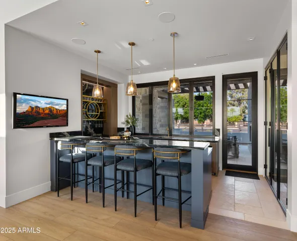 a view of a a dining room with furniture window and wooden floor