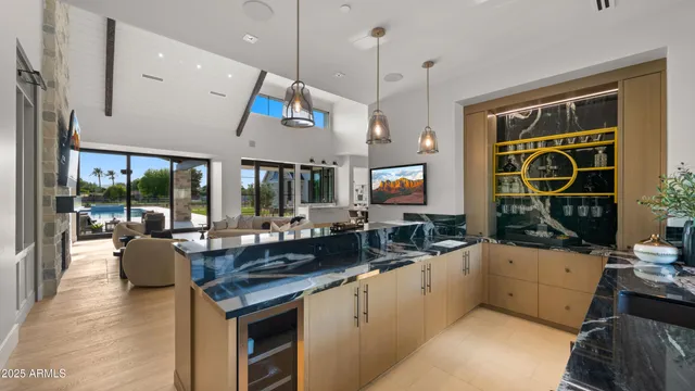 a kitchen with stainless steel appliances a stove a microwave a sink and cabinets