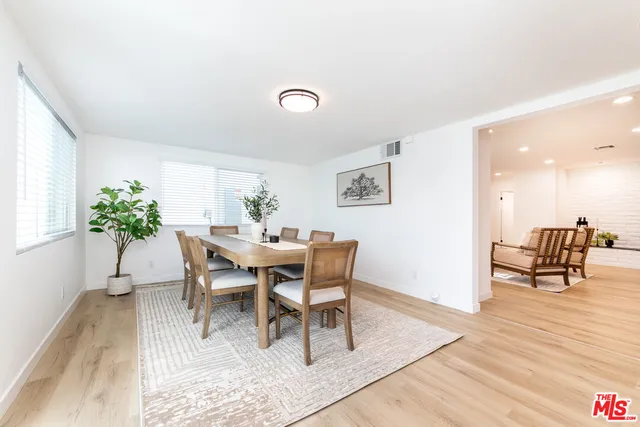 a dining room with furniture and wooden floor