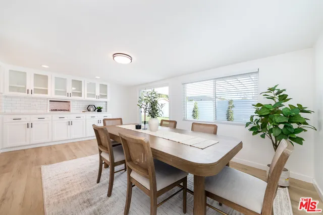 a view of a dining room with furniture and a potted plant