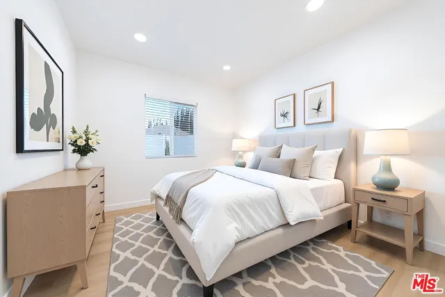 a bedroom with a bed and a lamp