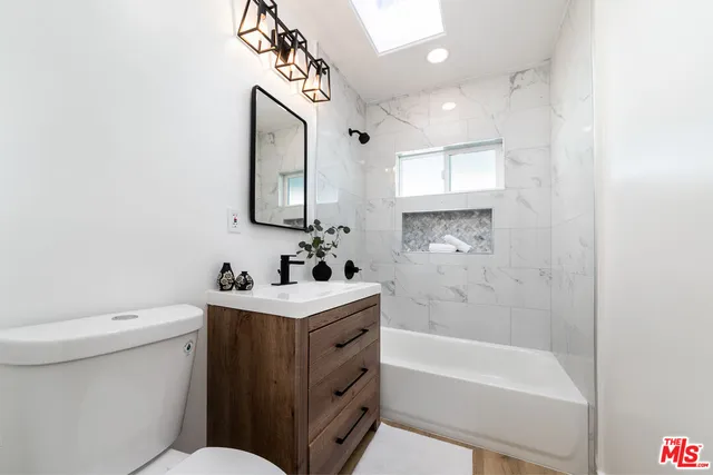a bathroom with a sink a toilet and bathtub