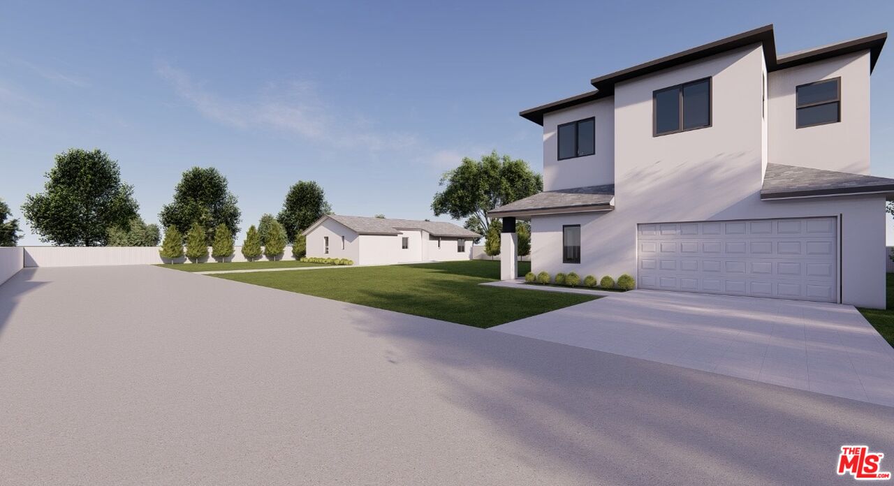 8446 Penfield Avenue Winnetka, CA 91306 - Photo 39 of 46 a front view of a house with a yard and garage