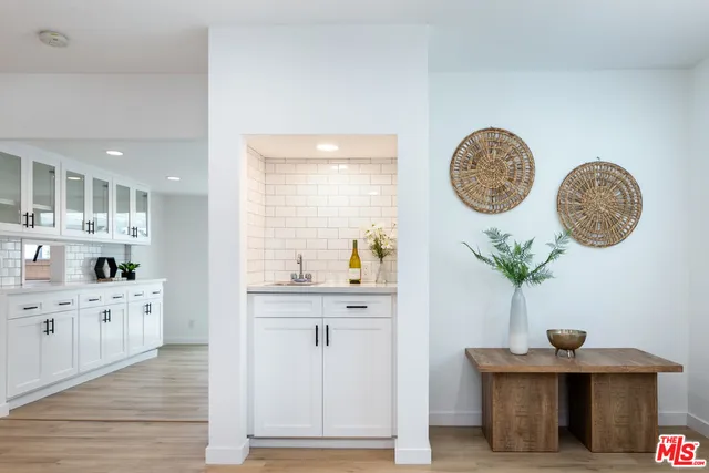 a kitchen with cabinets and wooden floor