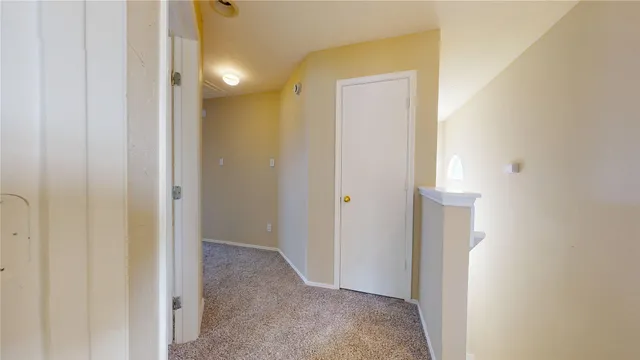 a view of a hallway with a bathroom