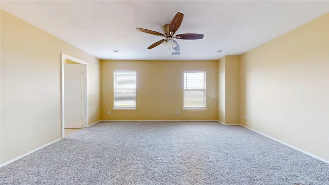 a view of a livingroom with a ceiling fan and window