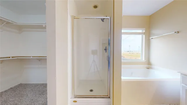a bathroom with a glass shower door