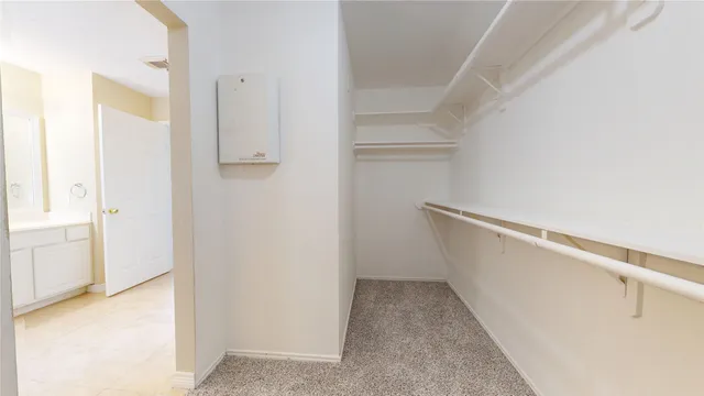 a view of walk in closet with empty racks