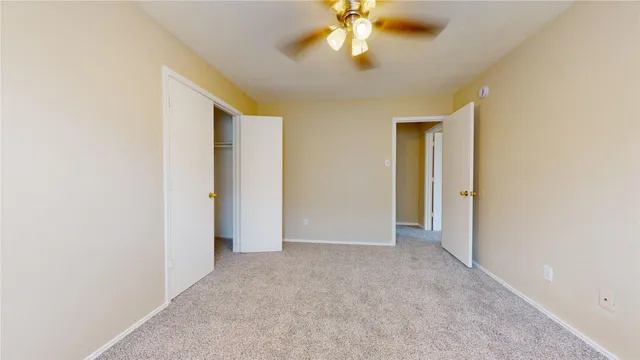 an empty room with a empty space and a ceiling fan