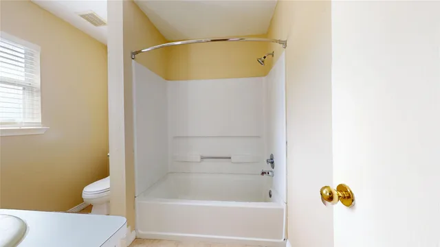 a bathroom with a shower and a toilet