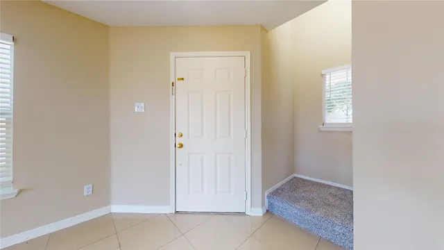 a view of an entryway with front door