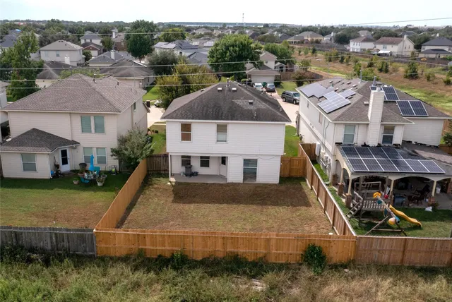an aerial view of a house with a yard