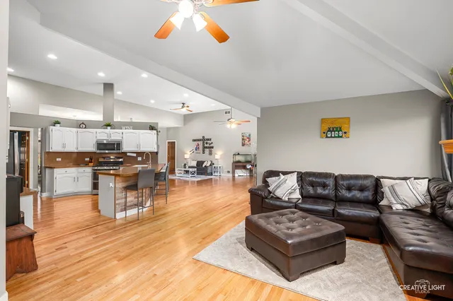 a living room with furniture and kitchen view