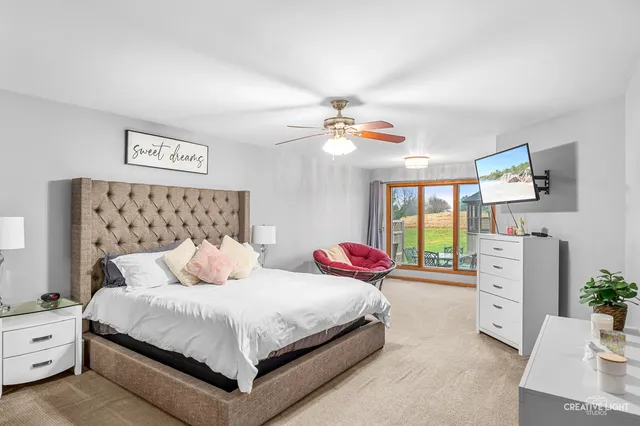 a bedroom with bed and a chandelier