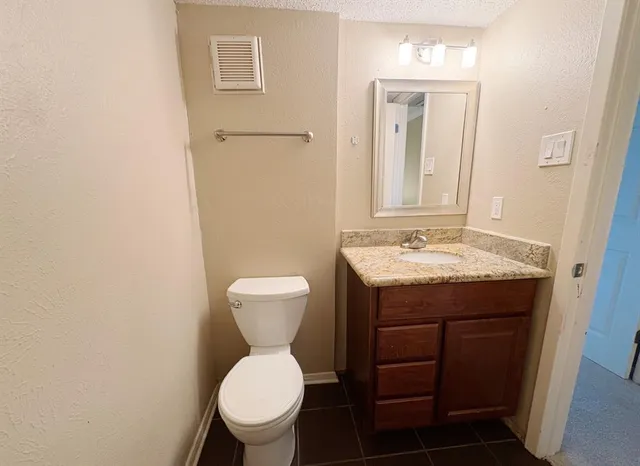 a bathroom with a sink toilet and mirror