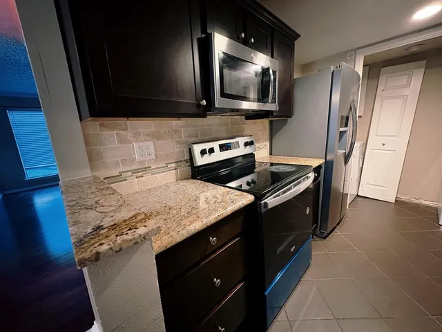 a kitchen with a sink stove and microwave
