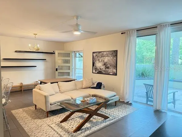 a living room with stainless steel appliances kitchen island granite countertop furniture and a view of kitchen