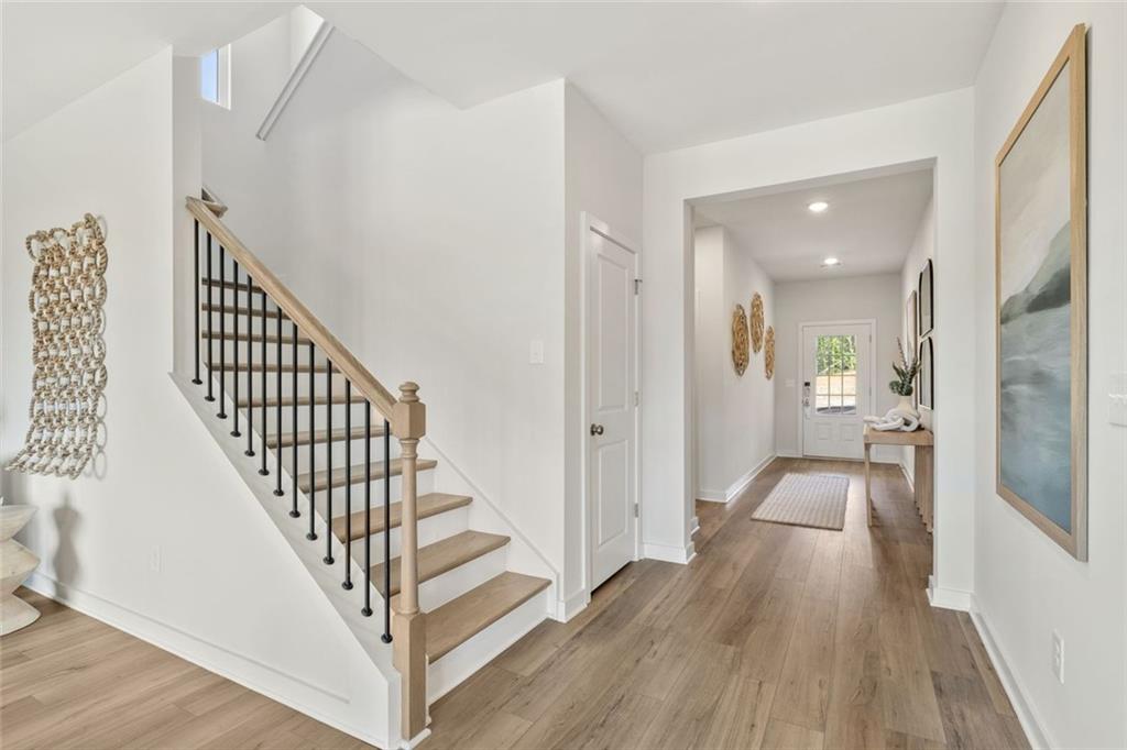 2682 Harbor Rdg Pass Gainesville, GA 30507 - Photo 22 of 42 a view of a hallway with wooden floor and staircase