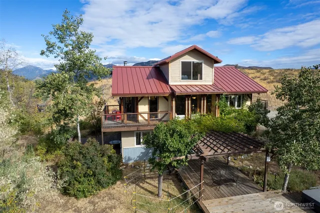 a front view of a house with yard and trees
