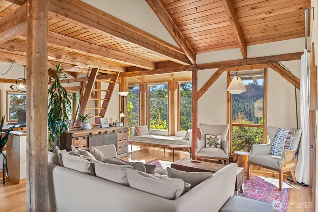 a living room with furniture and large windows