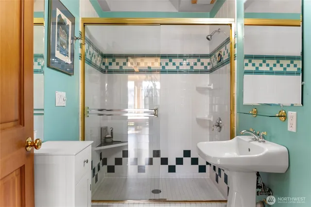 a bathroom with a sink a mirror and a shower