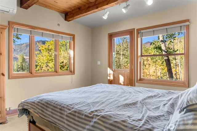 a bedroom with a large bed and a large window