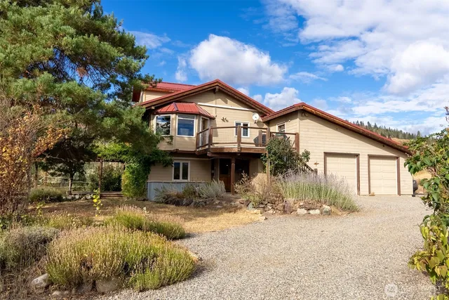 a view of a patio with table and chairs under an umbrella