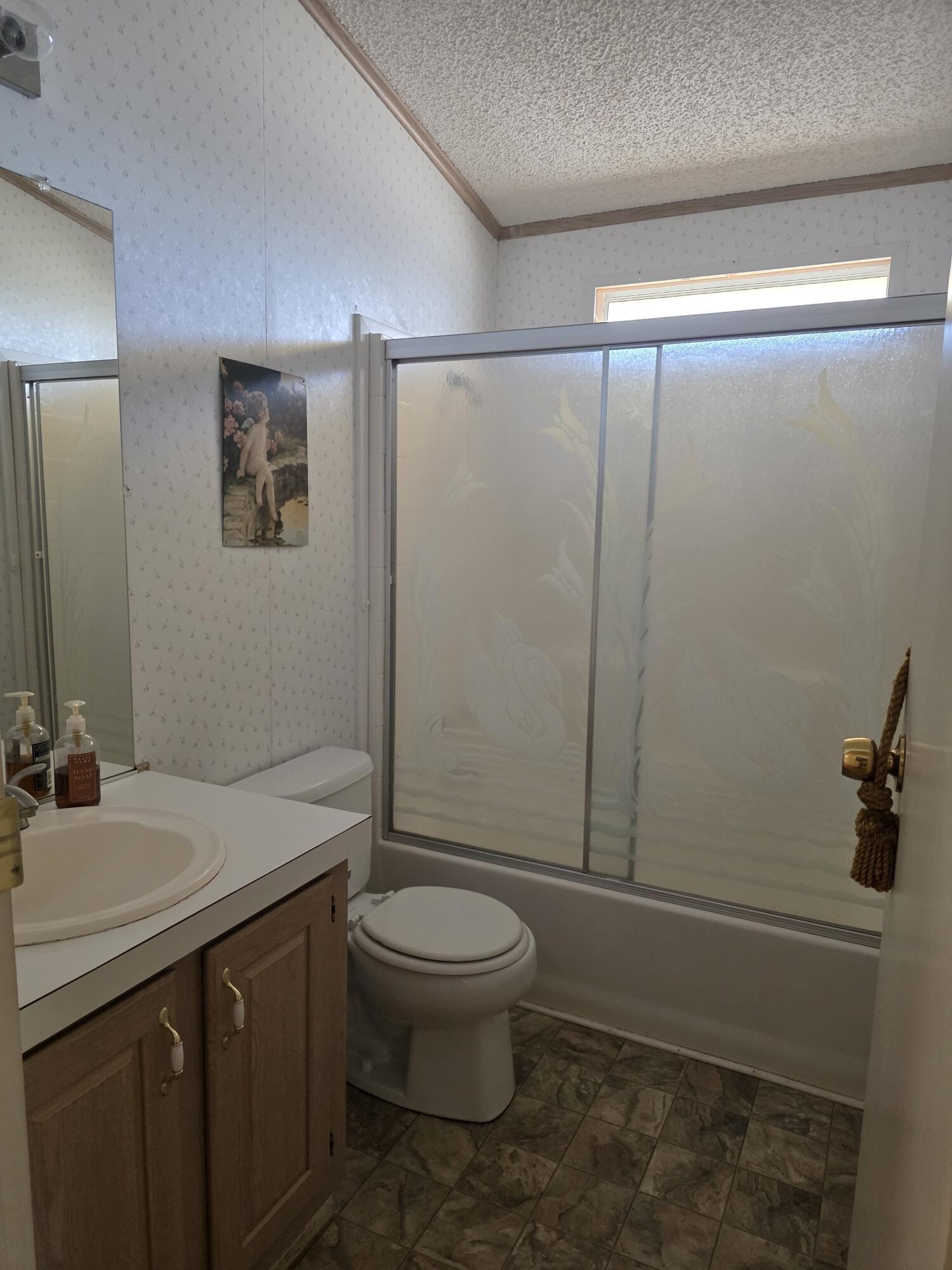 10595 Hot Mineral Spa Road, Unit 195 Niland, CA 92257 - Photo 24 of 32 a bathroom with a sink a toilet and shower