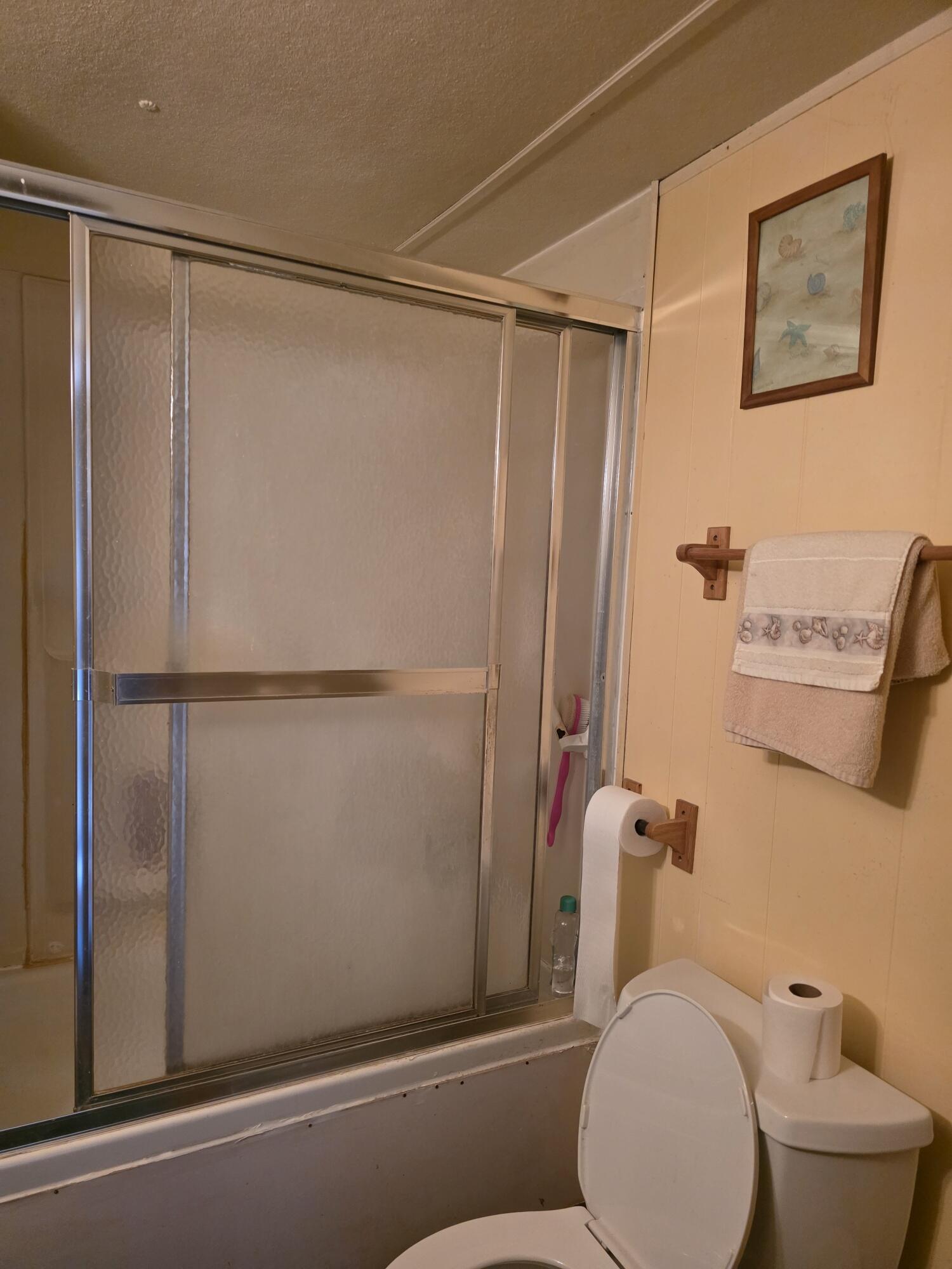 10595 Hot Mineral Spa Road, Unit 195 Niland, CA 92257 - Photo 25 of 32 a bathroom with a shower and a toilet