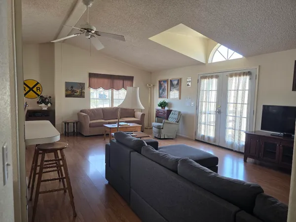 a living room with furniture a rug and a window