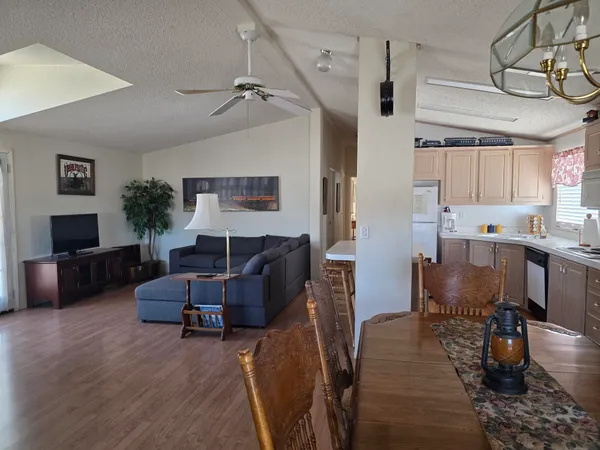 a view of a house with wooden deck and furniture