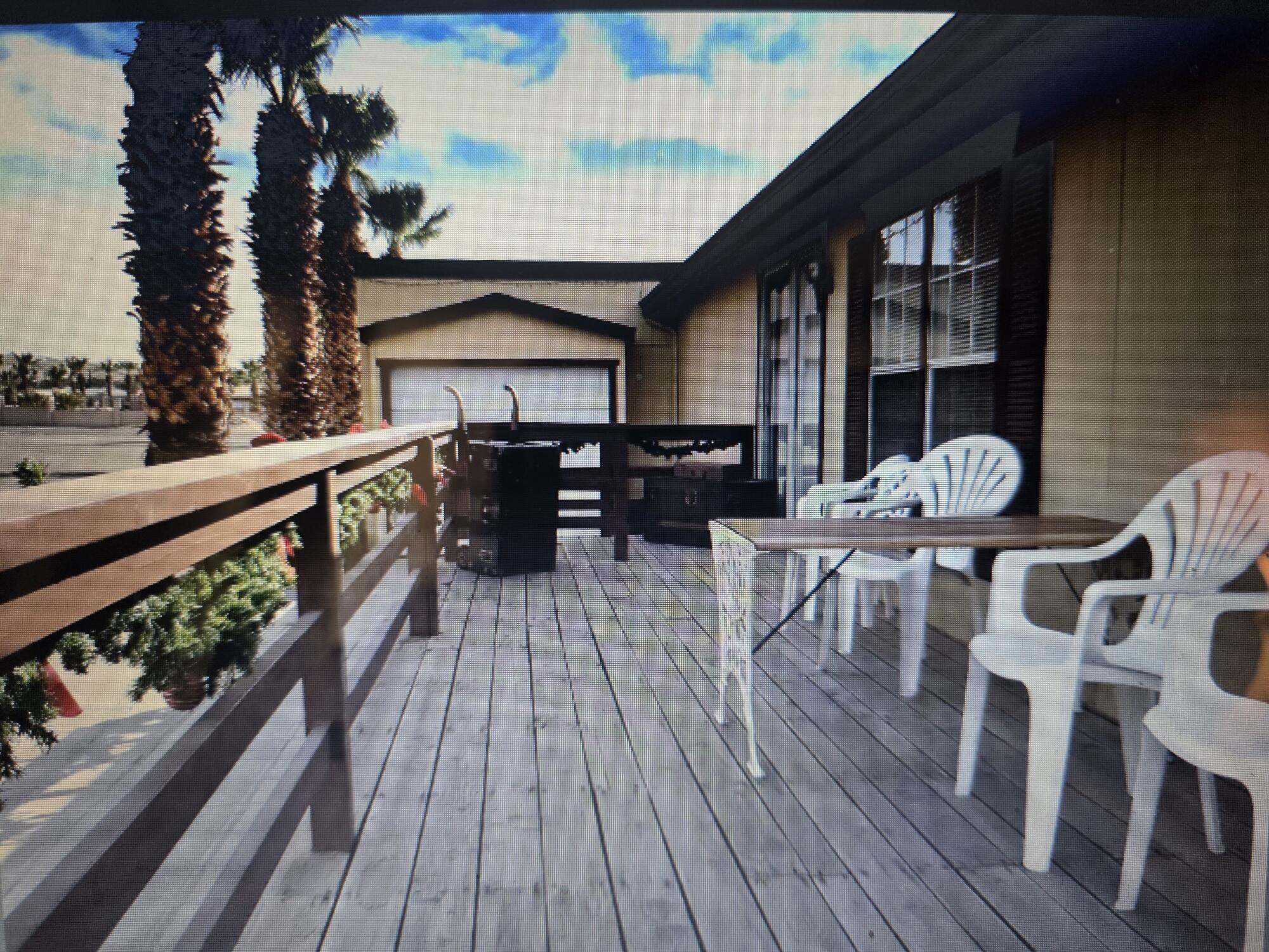 10595 Hot Mineral Spa Road, Unit 195 Niland, CA 92257 - Photo 10 of 32 a view of a house with wooden deck and furniture