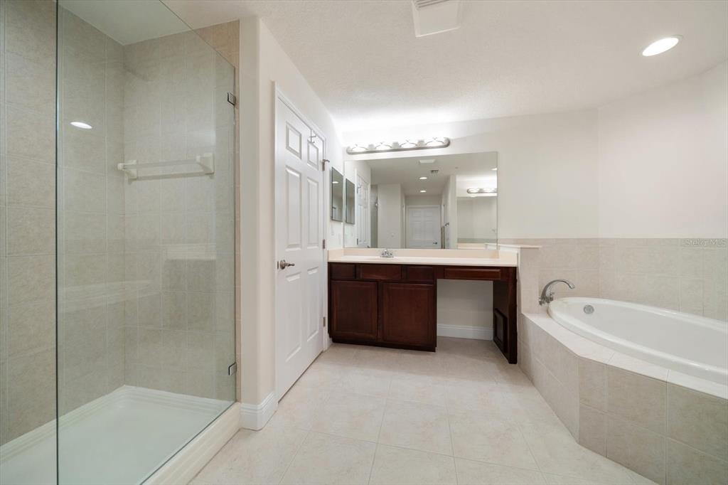 7069 Key Haven Road, Unit 304 Seminole, FL 33777 - Photo 11 of 50 a bathroom with a tub a sink shower and mirror