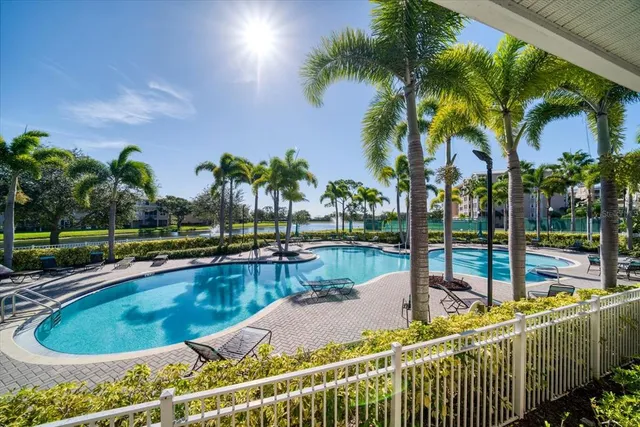 a view of a swimming pool with a patio and a yard